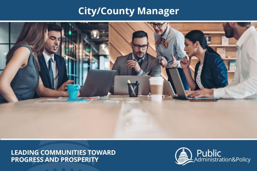 City/County Manager at a desk with other city officials