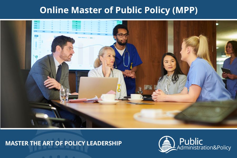 A group of students and interns sitting around a conference table, representing the Master of Public Policy program