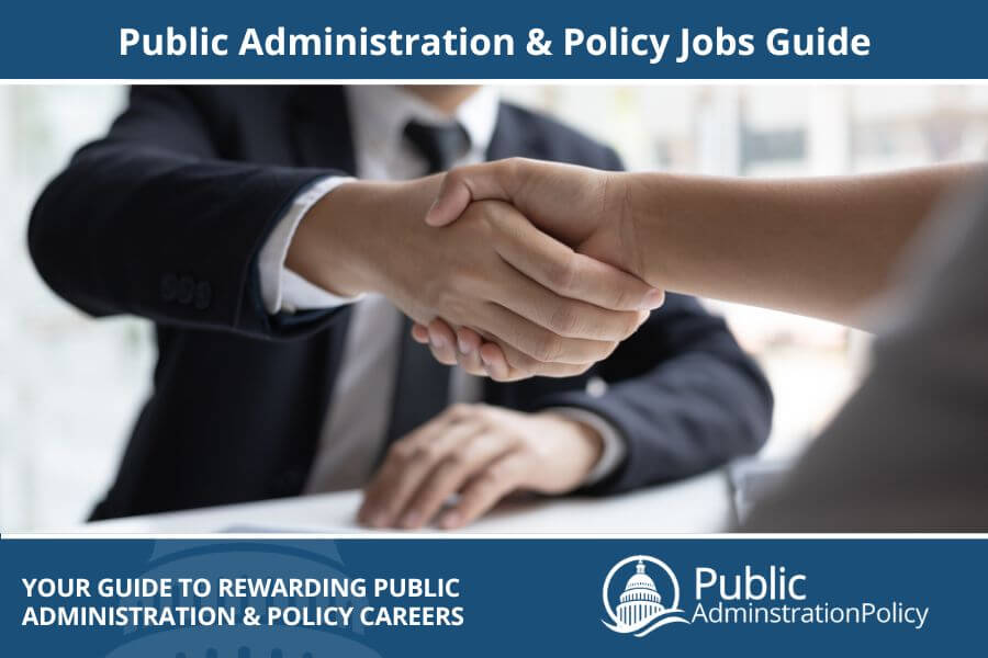 Interviewer shaking hands with a job candidate, highlighting opportunities in Public Administration & Policy Jobs.